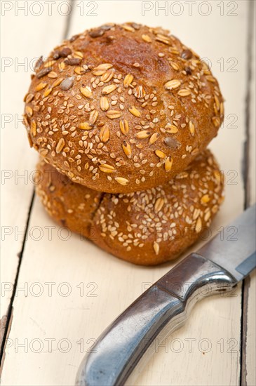 Fresh organic bread over rustic table macro closeup