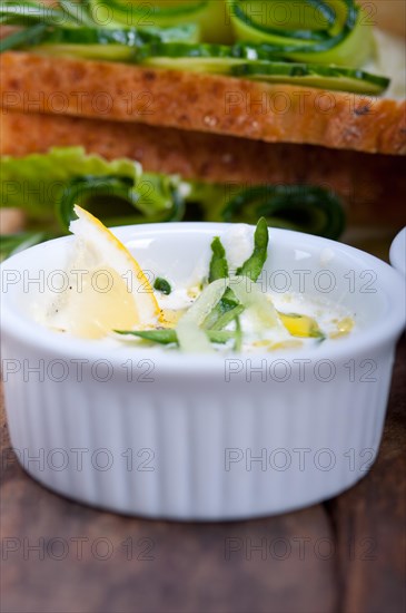 Fresh vegetarian sandwich with garlic cheese dip salad on rustic table