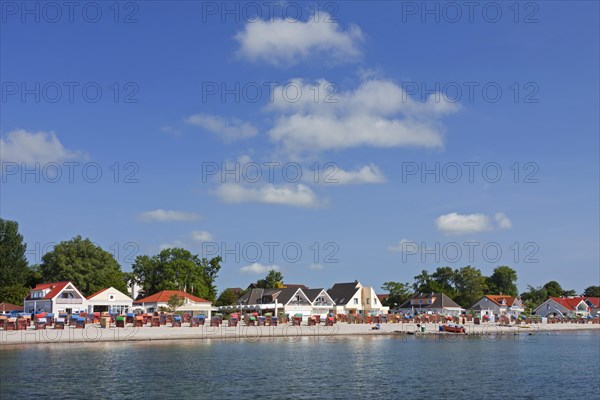 Roofed wicker beach chairs along the Baltic Sea at Kellenhusen