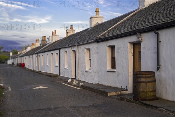 Row of white-harled workers cottages in former slate-mining village Ellenabeich on the isle of Seil