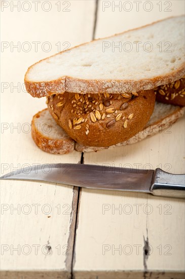 Fresh organic bread over rustic table macro closeup