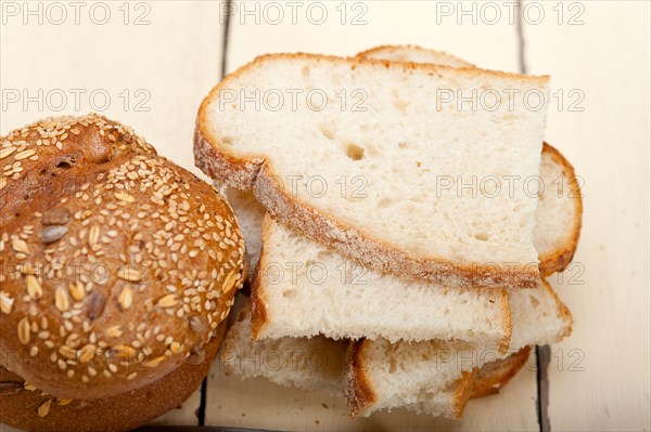 Fresh organic bread over rustic table macro closeup