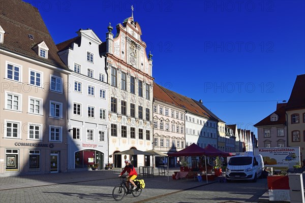 Cyclist in front of the market in the old town centre