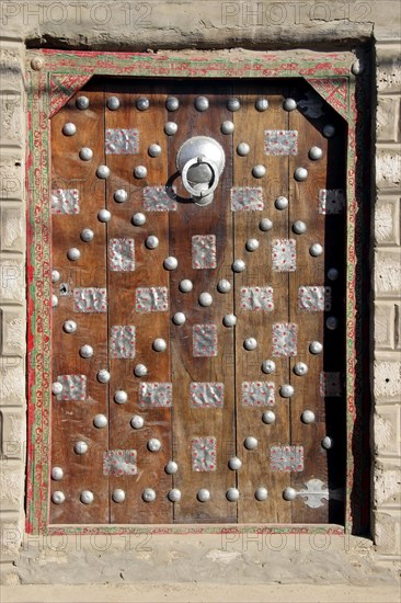 Old door in traditional Moroccan style of mud house in the city Timbuktu