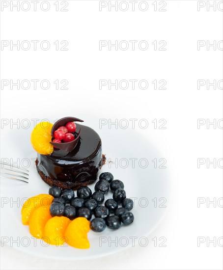 Chocolate cake and fresh fruit on top closeup macro