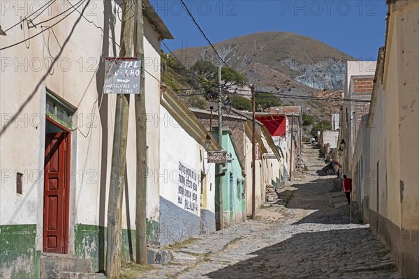 Cobbled street with adobe houses and shops the village Iruya