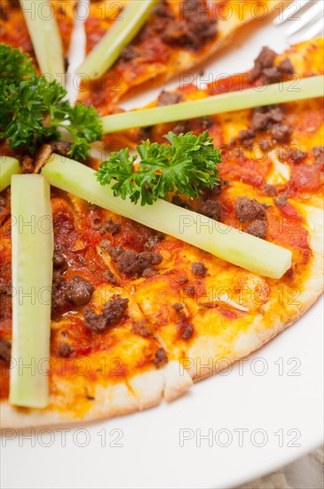 Fresh baked Turkish beef pizza with cucumber on top