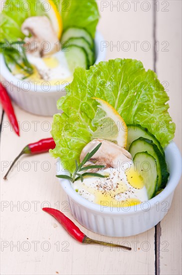 Fresh organic garlic cheese dip salad on a rustic table