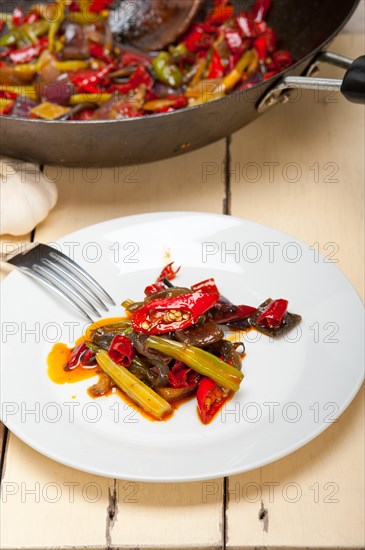 Fried chili pepper and vegetable on a iron wok pan