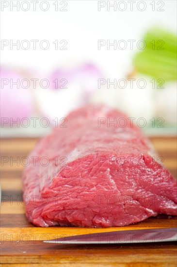 Raw beef and pork ribs with asparagus and herbs ready to cook