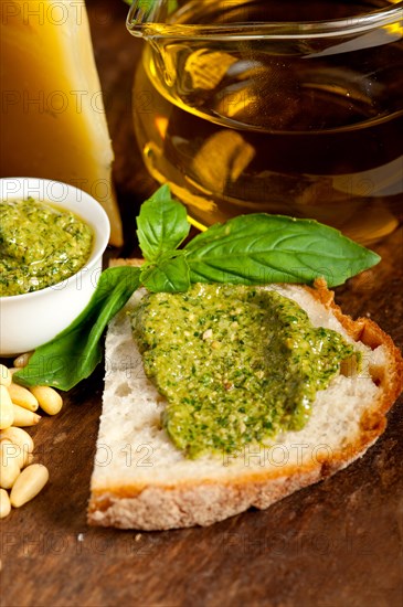 Italian basil pesto bruschetta ingredients over old wood macro