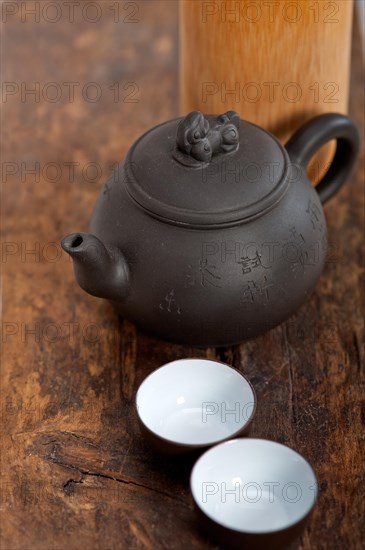 Chinese style pot and cups over old wood table