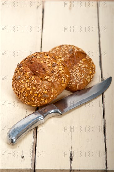 Fresh organic bread over rustic table macro closeup