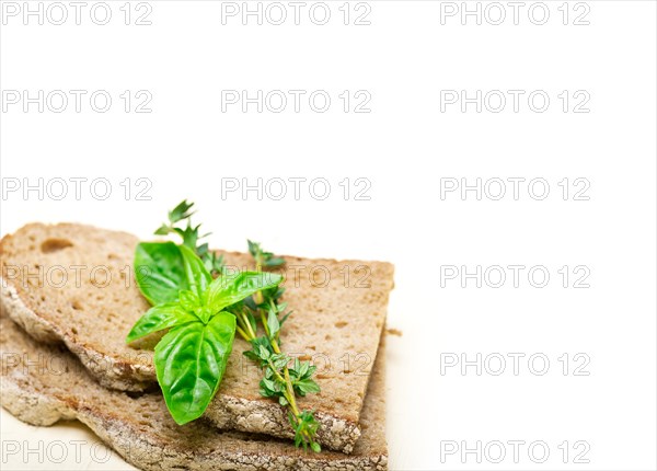 Rustic Italian bread basil and thyme simple snack on white wood table