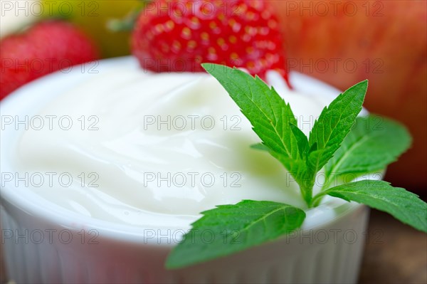 Fresh fruits and whole milk yogurt on a rustic wood table