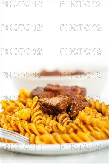 Fusilli pasta al dente with neapolitan style ragu meat sauce very different from bolognese style