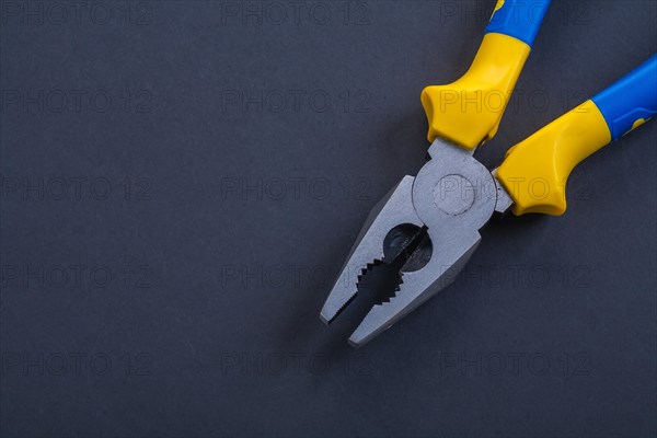 Pliers on black background close-up