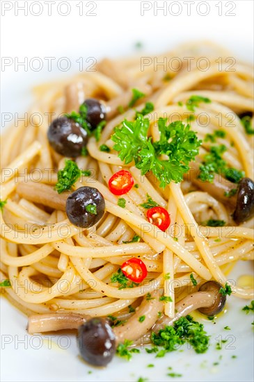 Italian pasta and mushroom sauce over rustic old wood