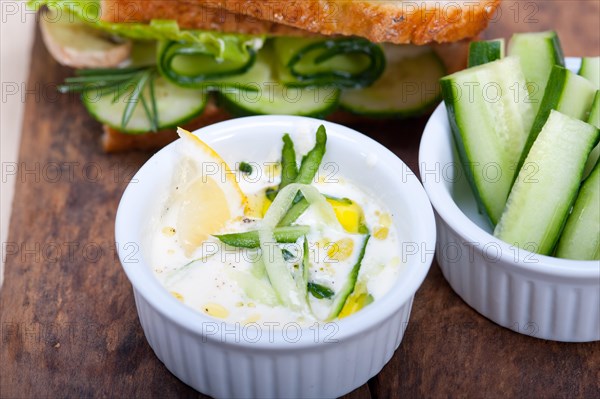 Fresh vegetarian sandwich with garlic cheese dip salad on rustic table