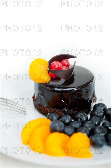 Chocolate cake and fresh fruit on top closeup macro