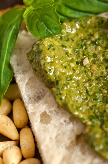 Italian basil pesto bruschetta ingredients over old wood macro