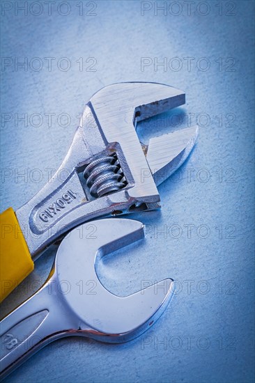 Metallic background with stainless steel adjustable spanner and hook spanner Repair concept
