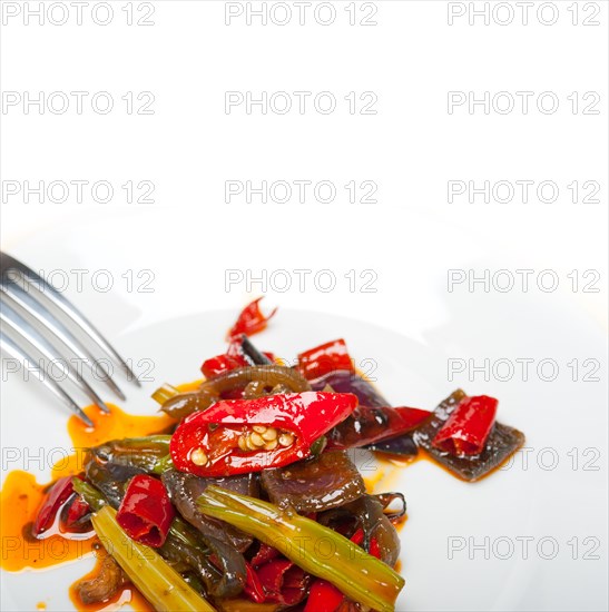 Fried chili pepper and vegetable on a iron wok pan