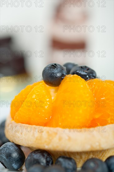 Fresh blueberry and tangerine orange cream cupcake homemade closeup macro