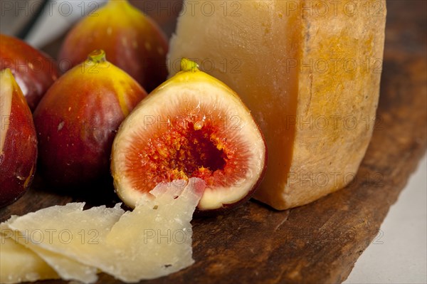 Italian pecorino cheese and fresh figs macro closeup over old wood boards