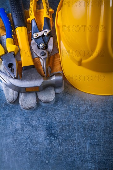 Composition of working tools on scratched vintage metallic background construction concept