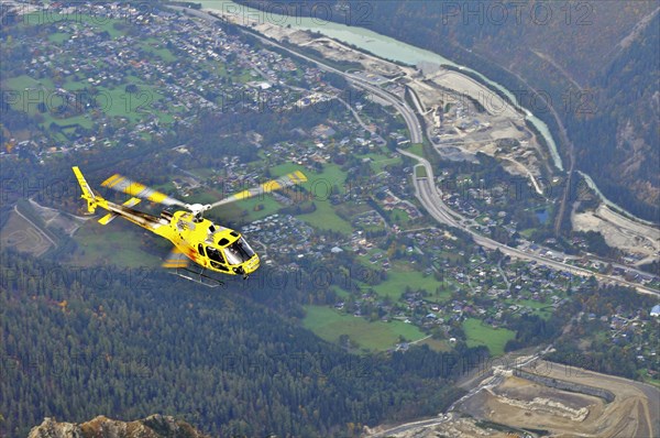 Helicoper with tourists returning from sightseeing tour flying over Chamonix