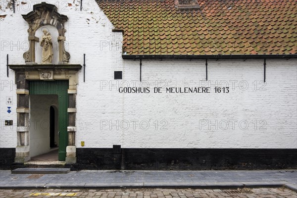 Almshouses De Meulenaere along cobbled alley in Bruges