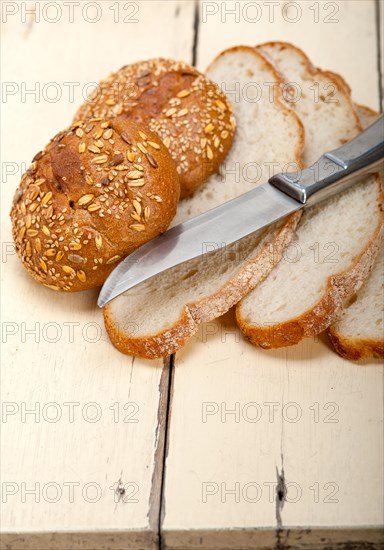 Fresh organic bread over rustic table macro closeup