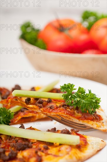 Fresh baked Turkish beef pizza with cucumber on top