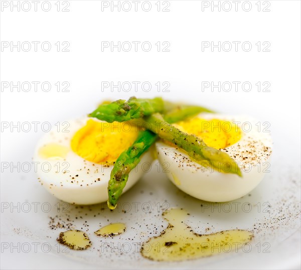 Boiled fresh green asparagus and eggs with extra virgin olive oil