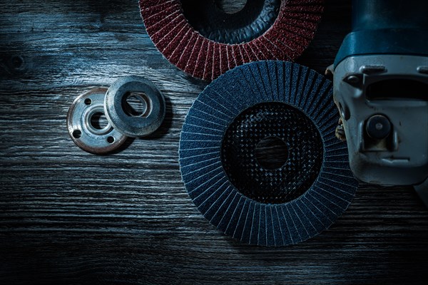 Hand angle grinder radial sanding discs on vintage wooden board