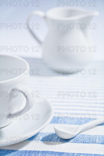 Composition of the white cup and spoon and jug