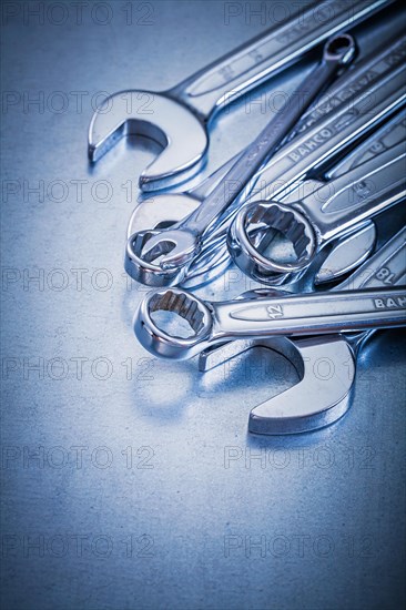 Flat spanner and open-end spanner on a metallic background Repair concept