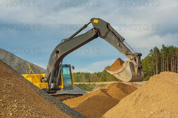 Excavator moves sand