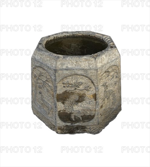 Ancient stone bucket finely carved with iced water over white backgroungd