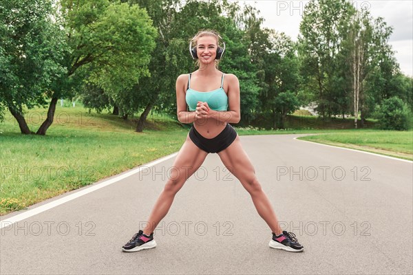 Charming girl does a workout in the park. The concept of a healthy lifestyle. Sports Equipment. Fitness style advertisement. Mixed media