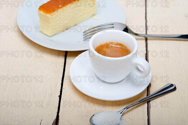 Italian espresso coffee and cheese cake over white wood table