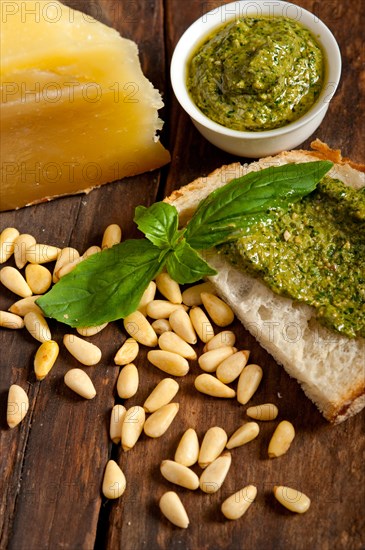 Italian basil pesto bruschetta ingredients over old wood macro