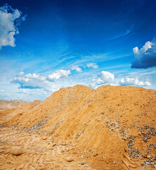 Big pile of construction sand on the background sky construction concept