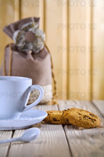 Blue coffee cup with biscuits and bag