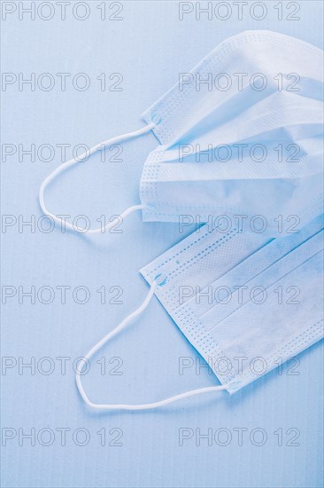 Disposable face masks on a blue background