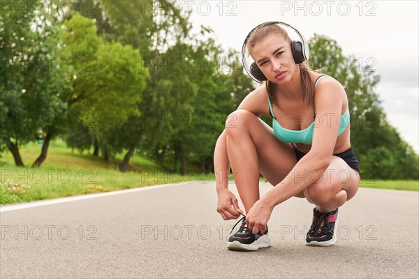 Charming girl does a workout in the park. The concept of a healthy lifestyle. Sports Equipment. Fitness style advertisement. Mixed media