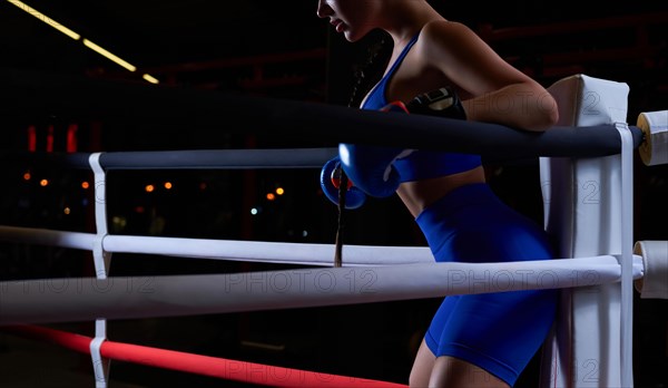 Noname photo of an athletic busty woman in a boxing ring. The concept of sports and mixed martial arts