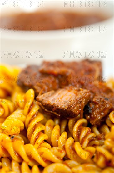 Fusilli pasta al dente with neapolitan style ragu meat sauce very different from bolognese style