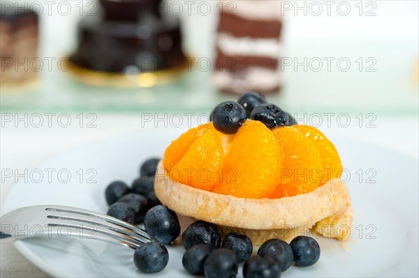 Fresh blueberry and tangerine orange cream cupcake homemade closeup macro